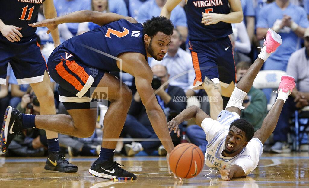 Gerry Broome Virginia's Braxton Key, left, and North Carolina's Brandon Robinson, right, chase a loose ball during the second half of an NCAA college basketball game in Chapel Hill, N.C., Monday, Feb. 11, 2019. Virginia won 69-61. (AP Photo/Gerry Broome)