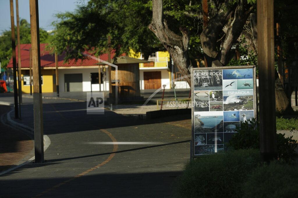 Adrian Vasquez In this May 2, 2020 photo, the sun shines on a poster advertising island tours and shuttered businesses ordered closed by the government as a measure to curb the spread of the new coronavirus, in San Cristobal, Galapagos Islands, Ecuador. Ecuador is among Latin American nations hit hardest by COVID-19. (AP Photo/Adrian Vasquez)