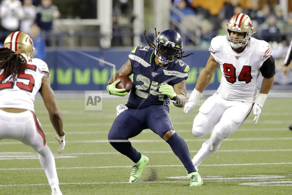 Ted S. Warren Seattle Seahawks' Marshawn Lynch (24) carries between San Francisco 49ers' Richard Sherman (25) and Solomon Thomas (94) during the second half of an NFL football game, Sunday, Dec. 29, 2019, in Seattle. (AP Photo/Ted S. Warren)