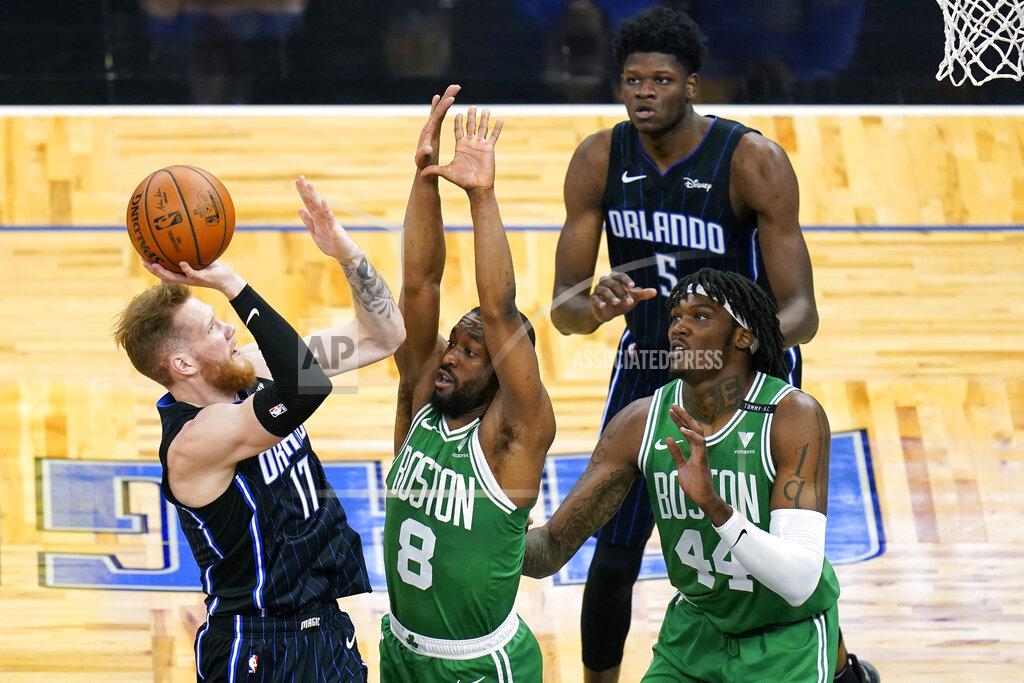 John Raoux Orlando Magic forward Ignas Brazdeikis (17) takes a shot over Boston Celtics guard Kemba Walker (8) and center Robert Williams (44) as Magic center Mo Bamba (5) looks on during the first half of an NBA basketball game, Wednesday, May 5, 2021, in Orlando, Fla. (AP Photo/John Raoux)