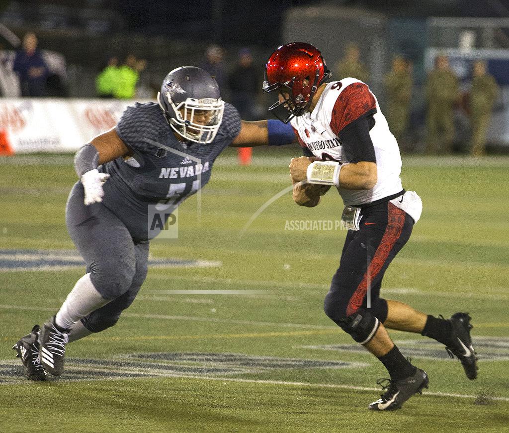 Tom R. Smedes San Diego State quarterback, right, is hit by Nevada's Dom Peterson (51) in the second half of an NCAA college football game in Reno, Nev., Saturday, Oct. 27, 2018. (AP Photo/Tom R. Smedes)