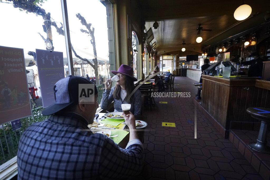 Jeff Chiu FILE - In this Nov. 12, 2020, file photo, a couple eat inside at the Buena Vista Cafe during the coronavirus outbreak in San Francisco. With the coronavirus coming back with a vengeance across the country and the U.S. facing a long, dark winter, governors and other elected officials are showing little appetite for reimposing the kind of lockdowns and large-scale business closings seen last spring. (AP Photo/Jeff Chiu, File)
