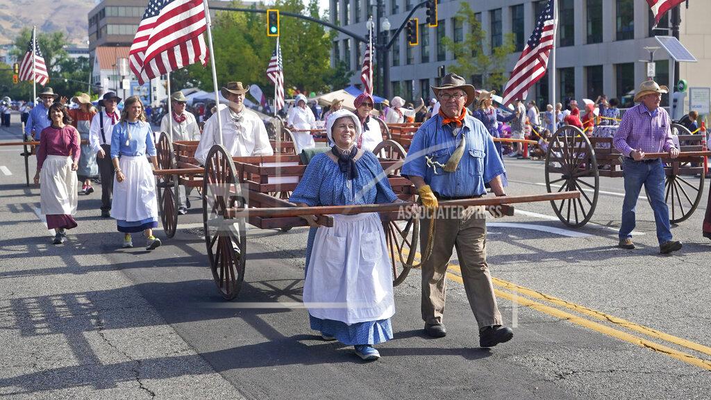 Rick Bowmer People pull handcarts during the Pioneer Day Parade, Friday, July 23, 2021, in Salt Lake City. People in Utah are gathering to celebrate the state's history and recognize early Mormon pioneers who trekked West in search of religious freedom. Pioneer Day is a beloved only-in-Utah holiday every July 24 that features parades, rodeos, fireworks and more. The festivities were canceled last year because of the pandemic.(AP Photo/Rick Bowmer)