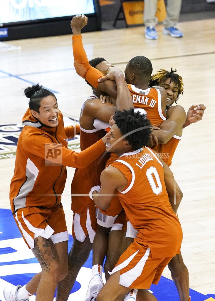 Kathy Kmonicek Texas guard Matt Coleman III (2) is hugged by teammates after Texas beat North Carolina 69-67 to win the NCAA college basketball game for the championship of the Maui Invitational, Wednesday, Dec. 2, 2020, in Asheville, N.C. Coleman was the MVP with the winning basket and high score of 22 points. (AP Photo/Kathy Kmonicek)