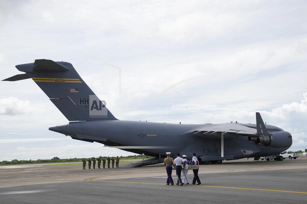 Sakchai Lalit U.S. military carry the possible remains of a WWII U.S. airman found in northern Thailand to a waiting C-17 during a repatriation ceremony Wednesday, May 18, 2022, at the U-Tapao Air Base in Rayong province, eastern Thailand. The possible human remains were found at a crash site in a rice field in northern Thailand by the Defense POW/MIA Accounting Agency and were sent to Hawaii where they will be tested to see if they belong to a U.S. pilot who went missing in 1944. (AP Photo/Sakchai Lalit)