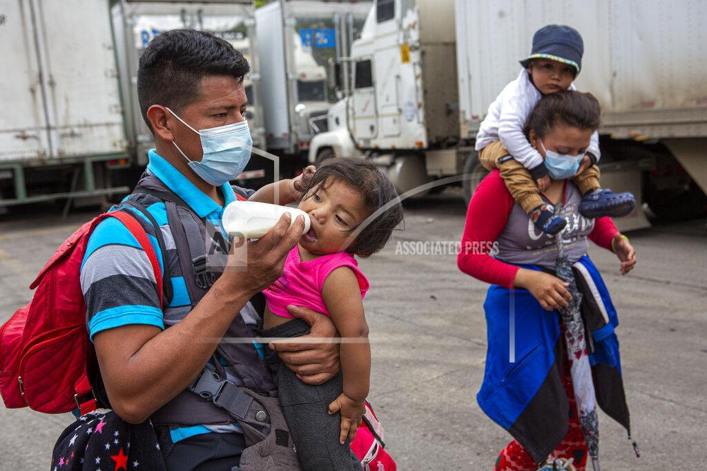 Oliver De Ros Honduran migrants walk to the border crossing after being transported in an army truck to El Florido, Guatemala, a border point between Guatemala and Honduras, Tuesday, Jan. 19, 2021. A once large caravan of Honduran migrants that pushed its way into Guatemala last week had dissipated by Tuesday in the face of Guatemalan security forces. (AP Photo/Oliver de Ros)
03104