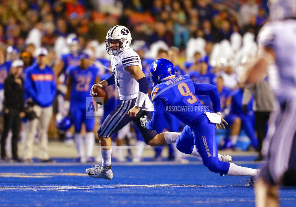 Steve Conner BYU quarterback Zach Wilson (11) scrambles away from Boise State linebacker Desmond Williams (9) during the first half of an NCAA college football game Saturday, Nov. 3, 2018, in Boise, Idaho. (AP Photo/Steve Conner)