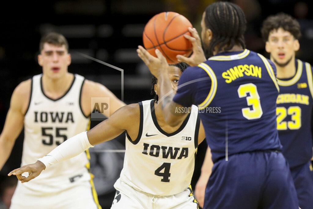 Rebecca F. Miller Iowa guard Bakari Evelyn (4) keeps an eye on the ball as Michigan Wolverines guard Zavier Simpson (3) looks to pass it during the first half of an NCAA college basketball game Friday, Jan. 17, 2020, in Iowa City, Iowa. (Rebecca F. Miller/The Gazette via AP)