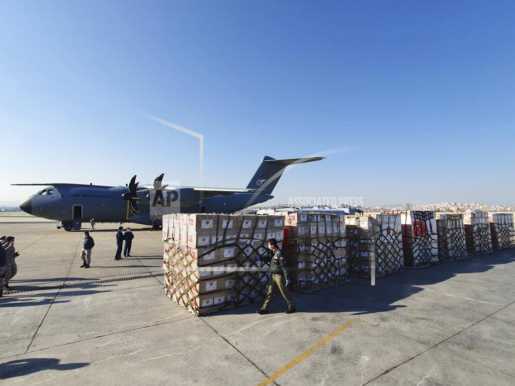 Uncredited In this handout photo provided by the Turkish Defense Ministry, Turkish soldiers prepare to load a military cargo plane with Personal Protection Equipment donated by Turkey to help United States combat the new coronavirus outbreak, at the Etimesgut airport outside Ankara, Turkey, Tuesday, April 28, 2020. Turkey is sending a planeload of surgical masks, N95 masks and hazmat suits to U.S. to help the country battle the coronavirus outbreak.(Turkish Defence Ministry via AP)
