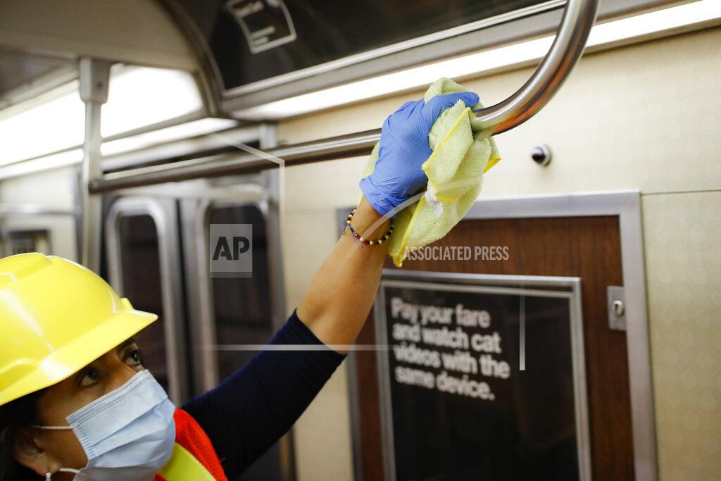 John Minchillo A contractor cleans a subway car at the 96th Street station to control the spread of COVID-19, Thursday, July 2, 2020, in New York. Mass transit systems around the world have taken unprecedented — and expensive — steps to curb the spread of the coronavirus, including shutting down New York subways overnight and testing powerful ultraviolet lamps to disinfect seats, poles and floors. (AP Photo/John Minchillo)