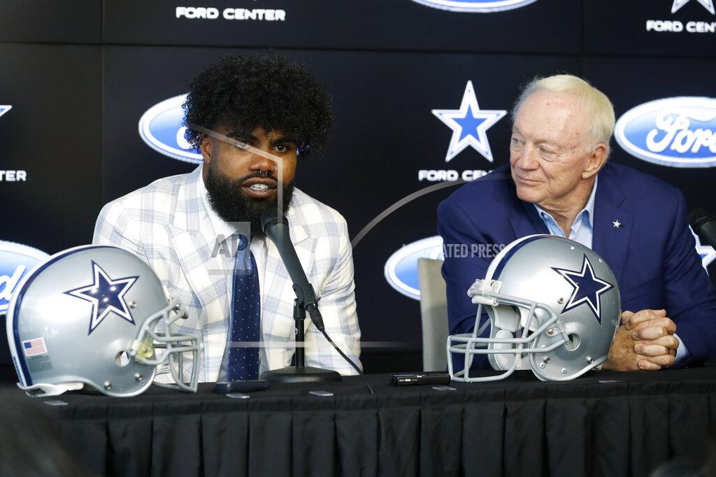 Tony Gutierrez Dallas Cowboys running back Ezekiel Elliott, left, makes comments during a news conference about his new contract as team owner Jerry Jones, right, looks on at the NFL football team's practice facility in Frisco, Texas, Thursday, Sept. 5, 2019. (AP Photo/Tony Gutierrez)