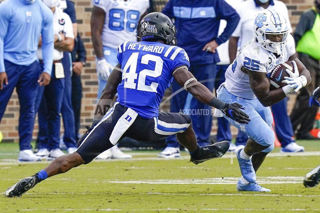 Jim Dedmon North Carolina running back Javonte Williams (25) runs away from Duke linebacker Shaka Heyward (42) during the second half of an NCAA college football game at Wallace Wade Stadium, Saturday, Nov. 7, 2020, in Durham, N.C. (Jim Dedmon/Pool Photo via AP)