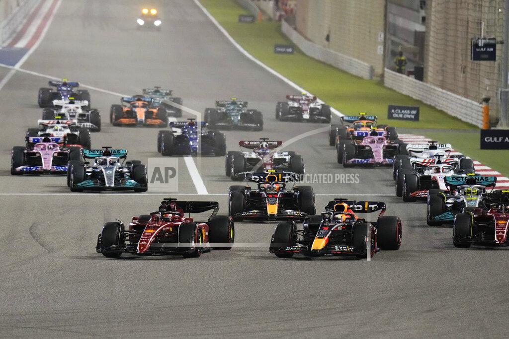 Hassan Ammar Ferrari driver Charles Leclerc of Monaco, left, and Red Bull driver Max Verstappen of the Netherlands lead at the start during the Formula One Bahrain Grand Prix it in Sakhir, Bahrain, Sunday, March 20, 2022. (AP Photo/Hassan Ammar)