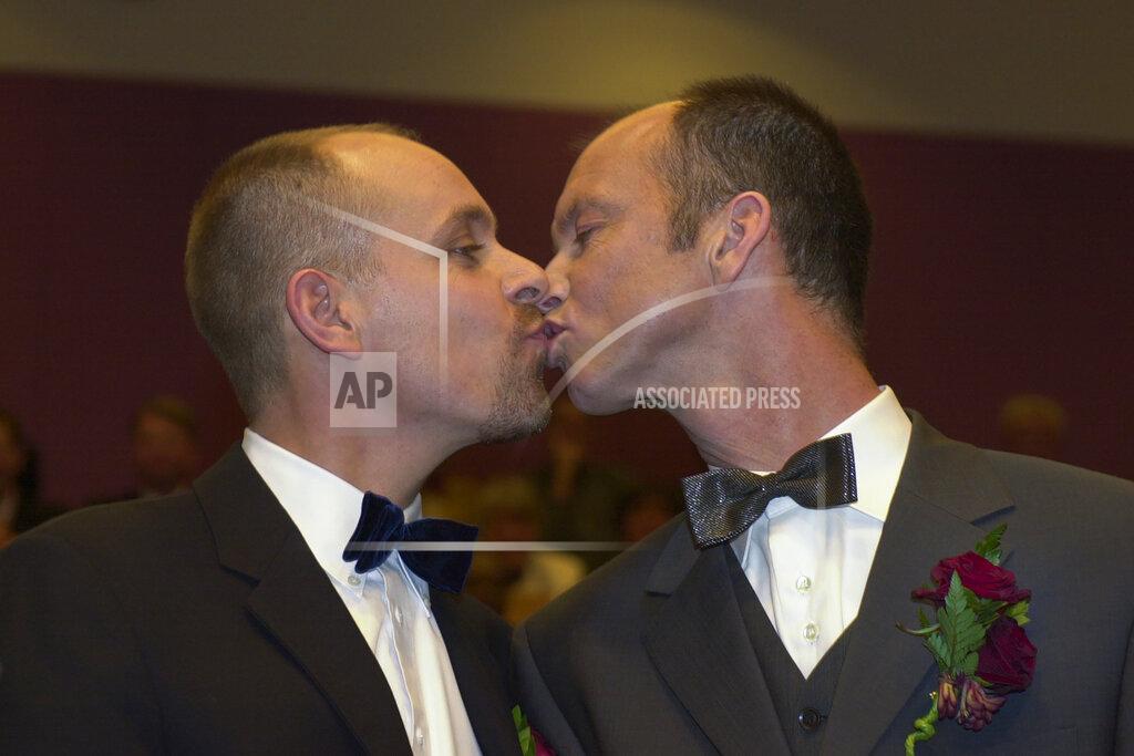 Peter Dejong Gert Kasteel, left, and Dolf Pasker kiss after exchanging vows at Amsterdam's City Hall early Sunday, April 1, 2001. The pair was among four couples to get married under a new law which took effect April 1, 2001, the world's first such law allowing same-sex marriages with equal rights. Same-sex marriage is now legal in 28 countries, including most of Western Europe, as well as in the self-governing island of Taiwan. (AP Photo/Peter Dejong)