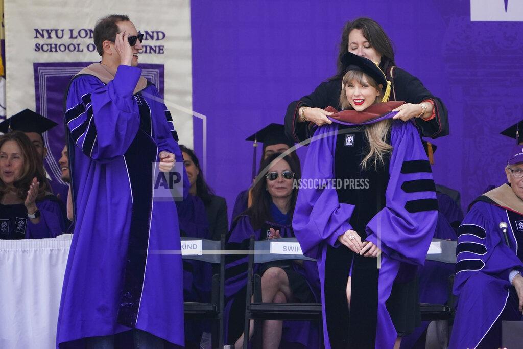 Seth Wenig Taylor Swift, right, receives an honorary degree during a graduation ceremony for New York University at Yankee Stadium in New York, Wednesday, May 18, 2022. (AP Photo/Seth Wenig)