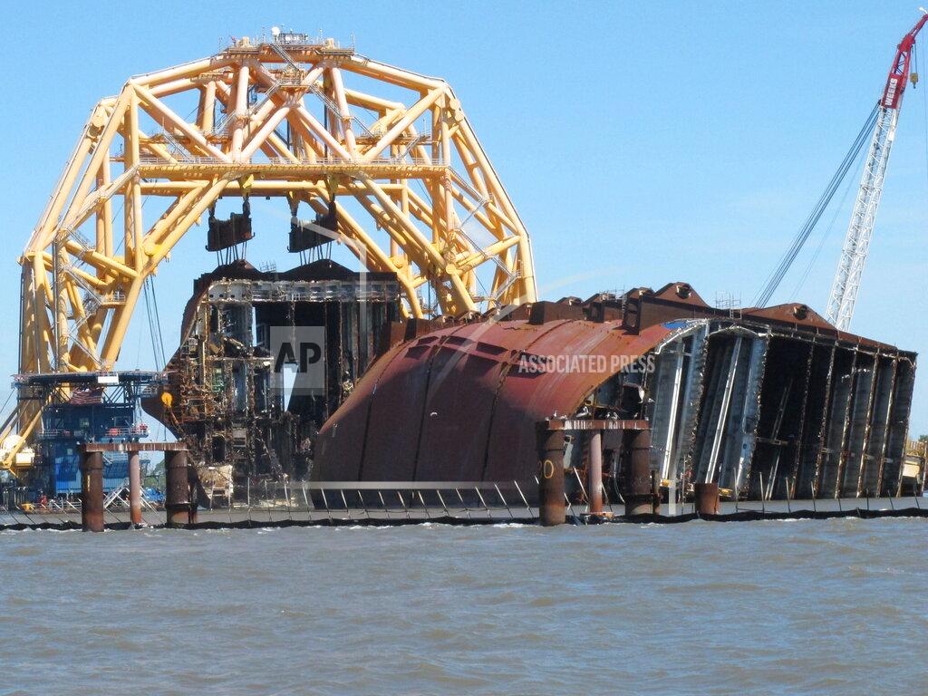 Russ Bynum A towering crane pulls the engine room section away from the remains of the capsized cargo ship Golden Ray on Monday, April 26, 2021, offshore of St. Simons Island, Ga. The South Korean vessel capsized with roughly 4,200 vehicles in its cargo decks in September 2019. The engine room section is the fourth giant chunk of the ship to be cut away and removed since demolition began in November 2020. (AP Photo/Russ Bynum)