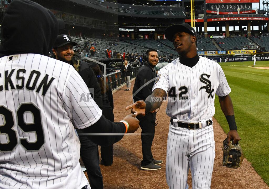 Matt Marton Chicago Bears player Eddie Jackson, left, and Chicago White Sox shortstop Tim Anderson, right, shake hands before Jackson threw out a ceremonial first pitch before a baseball game between the White Sox and the Kansas City Royals, Monday, April 15, 2019, in Chicago. No. 42 was worn to honor Jackie Robinson. (AP Photo/Matt Marton)