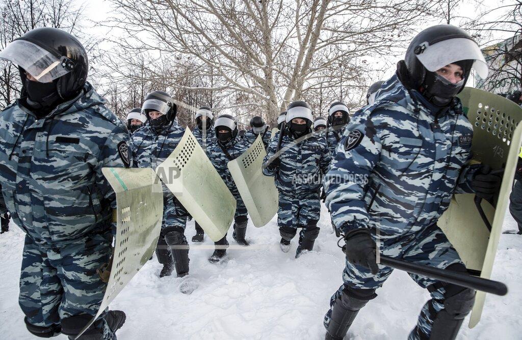 Anton Basanayev Riot police officers run during a protest against the jailing of opposition leader Alexei Navalny in Yekaterinburg, Russia, Saturday, Jan. 23, 2021. Russian police on Saturday arrested hundreds of protesters who took to the streets in temperatures as low as minus-50 C (minus-58 F) to demand the release of Alexei Navalny, the country's top opposition figure. A Navalny, President Vladimir Putin's most prominent foe, was arrested on Jan. 17 when he returned to Moscow from Germany, where he had spent five months recovering from a severe nerve-agent poisoning that he blames on the Kremlin. (AP Photo/Anton Basanayev)