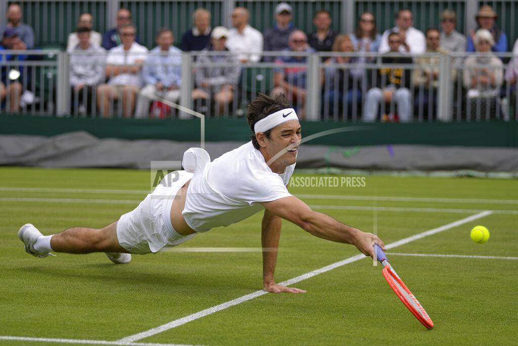 Alastair Grant Taylor Fritz of the US stretches to return to Britain's Alastair Gray in a second round men's single match on day four of the Wimbledon tennis championships in London, Thursday, June 30, 2022. (AP Photo/Alastair Grant)