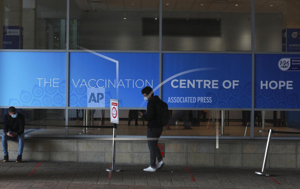 Nardus Engelbrecht) People outside the Vaccination Centre of Hope at the Cape Town International Convention Centre in Cape Town, South Africa, Tuesday July 27, 2021. Hitting its stride after a faltering start, South Africa’s mass vaccination campaign gave jabs to 220,000 people a day last week and is accelerating toward the goal of 300,000 per day. With large deliveries of doses arriving and some vaccines being assembled here, South Africa appears on track to inoculate about 35 million of its 60 million people by the end of the year. (AP Photo/Nardus Engelbrecht)