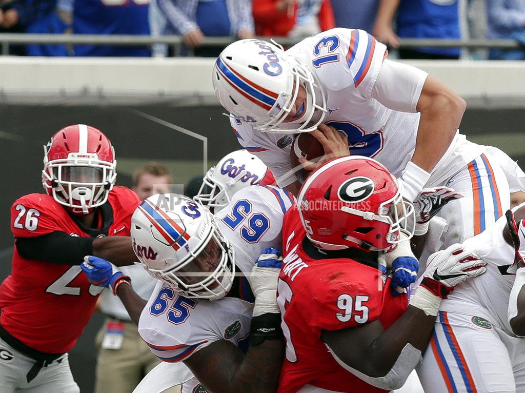John Raoux Florida quarterback Feleipe Franks (13) dives over the goal line for touchdown past Georgia defensive lineman Devonte Wyatt (95) during the first half of an NCAA college football game Saturday, Oct. 27, 2018, in Jacksonville, Fla. (AP Photo/John Raoux)