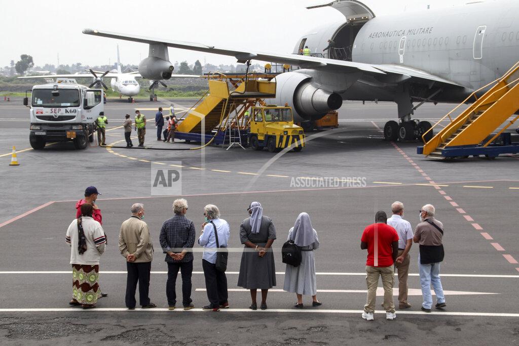 Justin Kabumba Unidentified people observe the airplane after it arrived to transport the bodies of Italian ambassador to Congo Luca Attanasio and Carabinieri officer Vittorio Iacovacci to the capital Kinshasa, at the airport in Goma, North Kivu province, Congo Tuesday, Feb. 23, 2021. Congo has dispatched a team to support investigators on the ground in Goma where the Italian ambassador to Congo, an Italian Carabinieri police officer and their driver were ambushed and killed Monday. (AP Photo/Justin Kabumba)