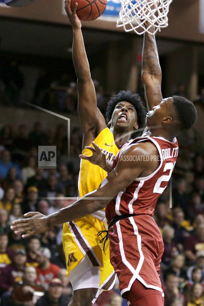 Nati Harnik Minnesota's Marcus Carr (5) goes for a basket against Oklahoma's Kristian Doolittle (21) during the second half of an NCAA college basketball game in Sioux Falls, S.D., Saturday, Nov. 9, 2019. (AP Photo/Nati Harnik)