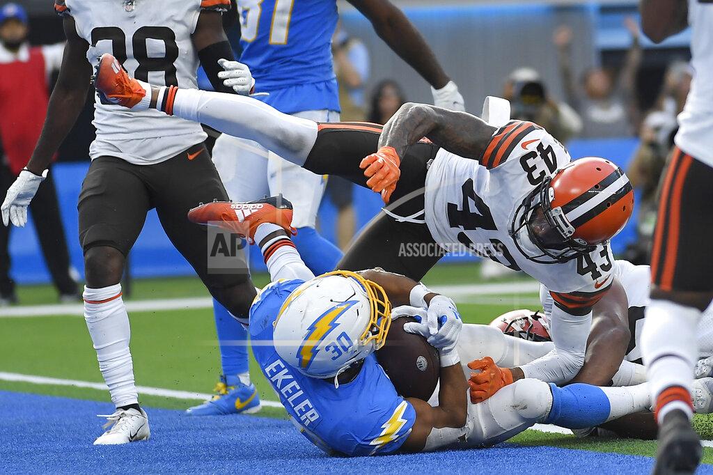 Kevork Djansezian Los Angeles Chargers running back Austin Ekeler (30) scores a touchdown under Cleveland Browns free safety John Johnson (43) during the second half of an NFL football game Sunday, Oct. 10, 2021, in Inglewood, Calif. (AP Photo/Kevork Djansezian)
