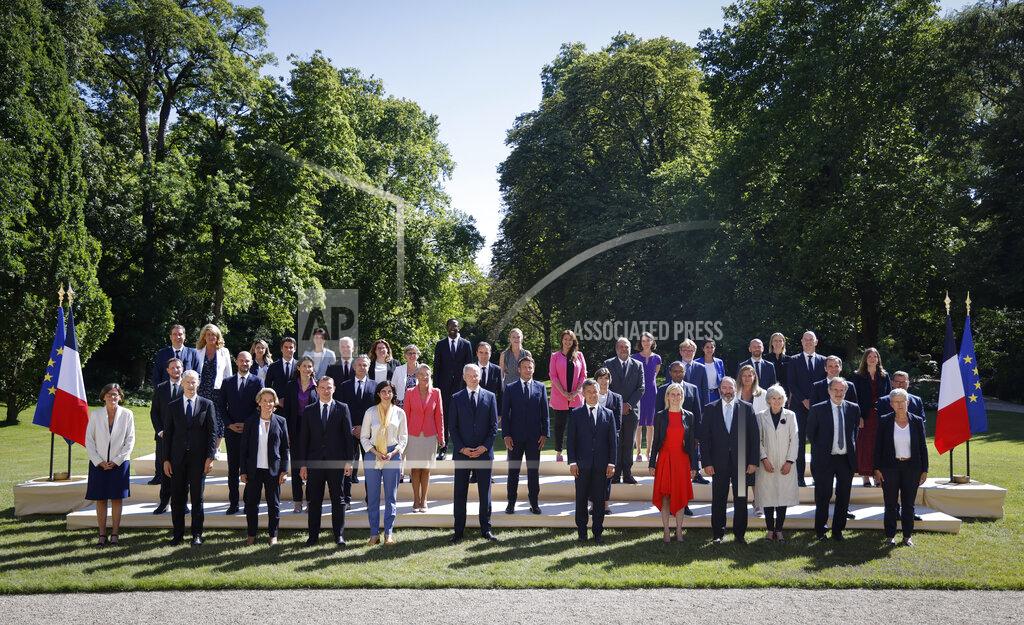 Ludovic Marin French President Emmanuel Macron, center, poses with minister in the gardens of the Elysee Palace in Paris, Monday, July 4, 2022. French President Emmanuel Macron rearranged his Cabinet on Monday in an attempt to adjust to a new political reality following legislative elections in which his centrist alliance failed to win a majority in the parliament. (Ludovic Marin, Pool via AP)