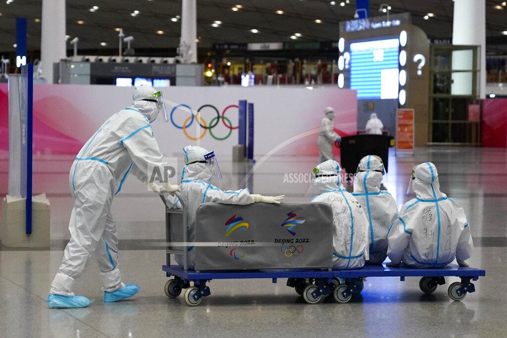 Ashley Landis Volunteers ride on a cart at Beijing-Capital International Airport after the conclusion of the 2022 Winter Olympics, Sunday, Feb. 20, 2022, in Beijing. (AP Photo/Ashley Landis)