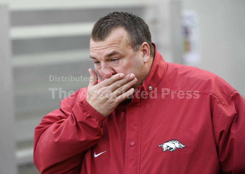 FILE - In this Nov. 24, 2017 file photo, Arkansas coach Bret Bielema wipes away tears as the senior players are introduced for the team's NCAA college football game against Missouri in Fayetteville, Ark. Bielema is returning to the Big Ten and his home state to coach Illinois. Illinois hired the former Wisconsin and Arkansas coach, hoping he can turn around a program with nine straight losing seasons. (AP Photo/Michael Woods)