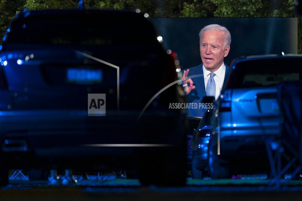 Carolyn Kaster Audience members watch from their cars as Democratic presidential candidate former Vice President Joe Biden, seen on a large monitor, speaks during a CNN town hall moderated by Anderson Cooper in Moosic, Pa., Thursday, Sept. 17, 2020. (AP Photo/Carolyn Kaster)