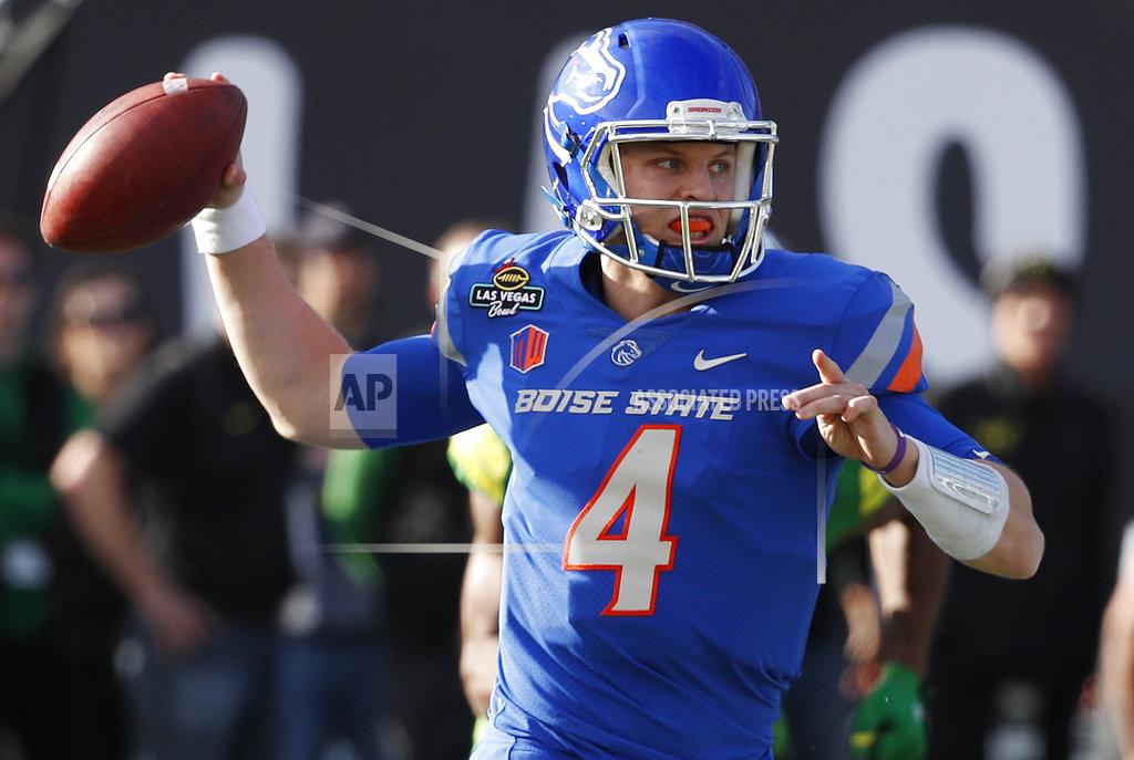 FILE - In this Dec. 16, 2017, file photo, Boise State quarterback Brett Rypien attempts a pass against Oregon during the first half of the Las Vegas Bowl NCAA college football game, in Las Vegas. MWC preseason offensive player of the year Brett Rypien has thrown for 9,876 yards, the highest total of any active Football Bowl Subdivision player. (AP Photo/John Locher, File)