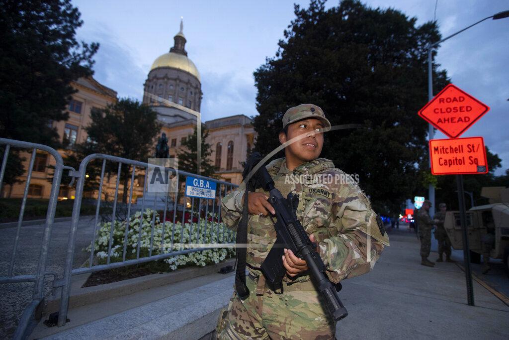 John Bazemore A member of the Georgia National Guard stands outside the State Capitol on Tuesday, July 7, 2020, in Atlanta. Georgia Gov. Brian Kemp mobilized the guard after a surge in violence over the weekend. (AP Photo/John Bazemore)