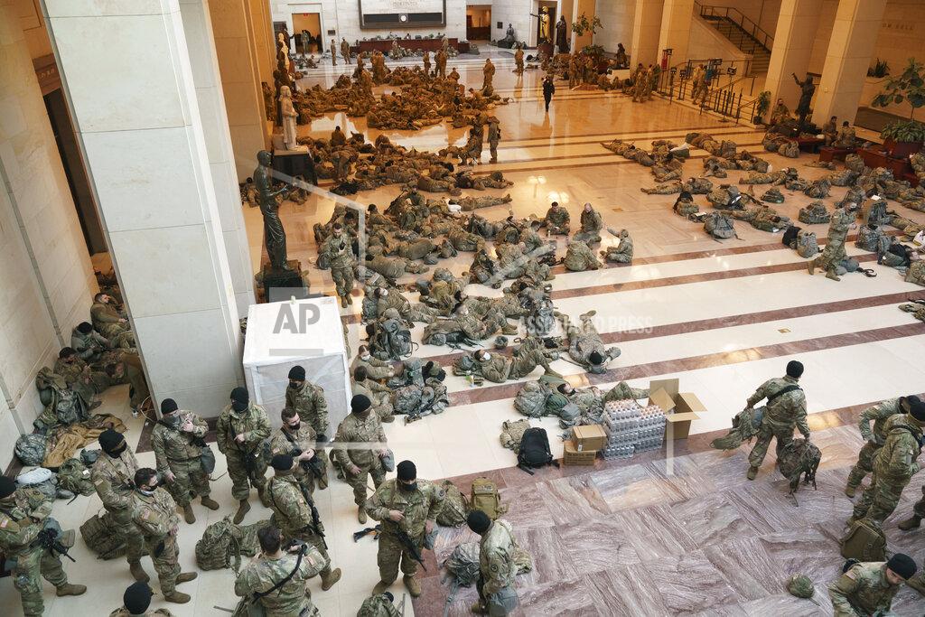 J. Scott Applewhite Hundreds of National Guard troops hold inside the Capitol Visitor's Center to reinforce security at the Capitol in Washington, Wednesday, Jan. 13, 2021. The House of Representatives is pursuing an article of impeachment against President Donald Trump for his role in inciting an angry mob to storm the Capitol last week. (AP Photo/J. Scott Applewhite)