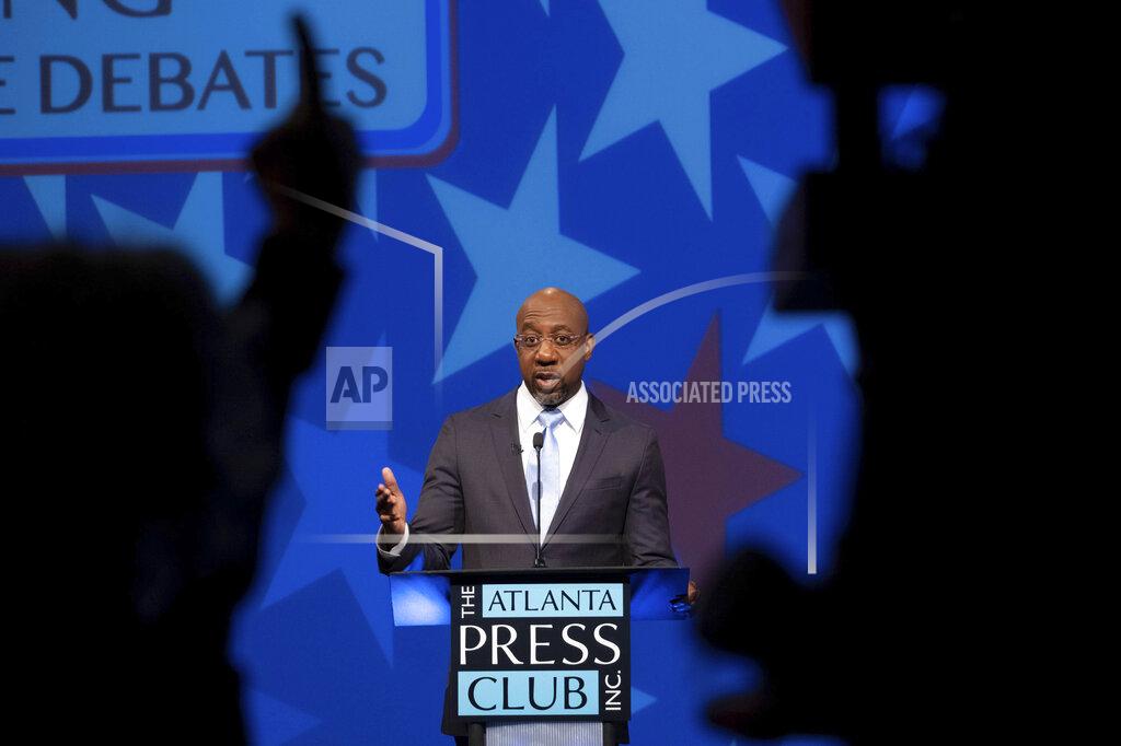 Democratic challenger Raphael Warnock speaks during a debate with Republican candidate for U.S. Senate Sen. Kelly Loeffler on Sunday, Dec. 6, 2020, in Atlanta. (AP Photo/Ben Gray, Pool)