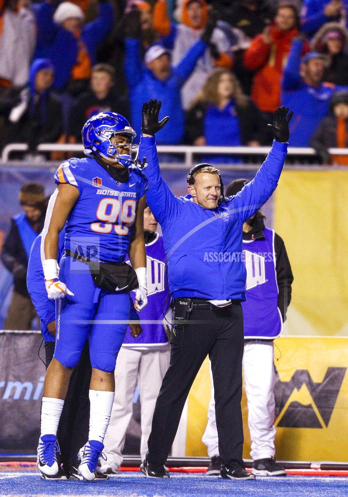 Steve Conner Boise State head coach Bryan Harsin and Boise State linebacker Curtis Weaver (99) celebrate a touchdown in the final seconds against Utah State in an NCAA college football game, Saturday, Nov. 24, 2018, in Boise, Idaho. Boise State won 33-24. (AP Photo/Steve Conner)