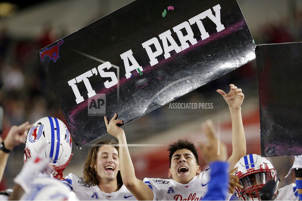 Michael Wyke SMU players hold up signs in the bench area as the clock ticks down in the fourth quarter of the team's 34-31 win over Houston in an NCAA college football game Thursday, Oct. 24, 2019, in Houston. (AP Photo/Michael Wyke)