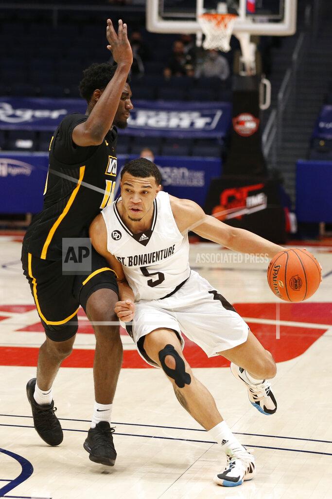 Jay Laprete FILE - St. Bonaventure's Jaren Holmes, right, drives to the basket against VCU's Vince Williams during the first half of an NCAA college basketball championship game for the Atlantic Ten Conference tournament Sunday, March 14, 2021, in Dayton, Ohio. No. 23 St. Bonaventure is ranked for the first time in 50 years and returns five seniors -- all starters -- from the team which went 16-5 and lost to eight-seeded LSU in the first round of the NCAA Tournament last year.(AP Photo/Jay LaPrete, File)