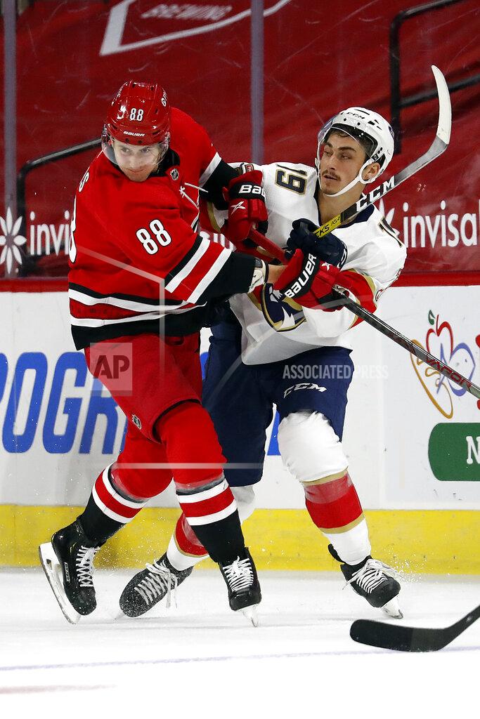 Karl B Deblaker Carolina Hurricanes' Martin Necas (88) collides with Florida Panthers' Mason Marchment (19) during the first period of an NHL hockey game in Raleigh, N.C., Sunday, March 7, 2021. (AP Photo/Karl B DeBlaker)