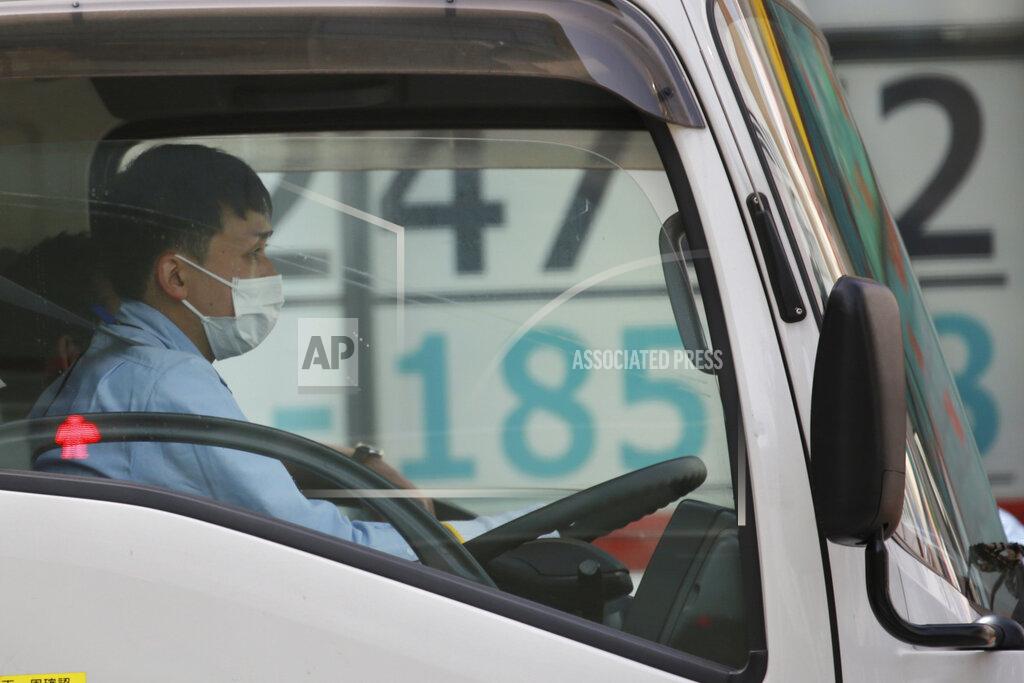 Koji Sasahara A car stops in front of an electronic stock board of a securities firm in Tokyo, Wednesday, March 31, 2021. Asian shares were mixed Wednesday as data showed a strong economic recovery in China but worries lingered about the coronavirus pandemic. (AP Photo/Koji Sasahara)
