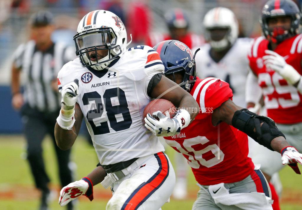 Rogelio V. Solis Auburn running back JaTarvious Whitlow (28) runs past Mississippi defenders towards the goal line, before fumbling the ball into the end zone, during the second half of an NCAA college football game on Saturday, Oct. 20, 2018, in Oxford, Miss. Auburn recovered the fumble for a touchdown and won 31-16. (AP Photo/Rogelio V. Solis)