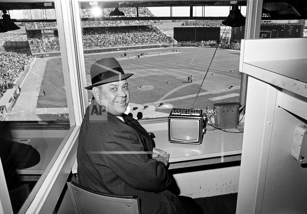 Gene Herrick FILE - In this Sept. 26, 1965, file photo, Calvin Griffith, president of the Minnesota Twins, sits in the press box at Metropolitan Stadium watching the Twins on television and awaiting the start of the Minnesota Vikings-Detroit Lions NFL game, in Minneapolis. The Minnesota Twins say they’ve removed a statue of former owner Calvin Griffith at Target Field, citing racist remarks he made in 1978. (AP Photo/Gene Herrick, File)