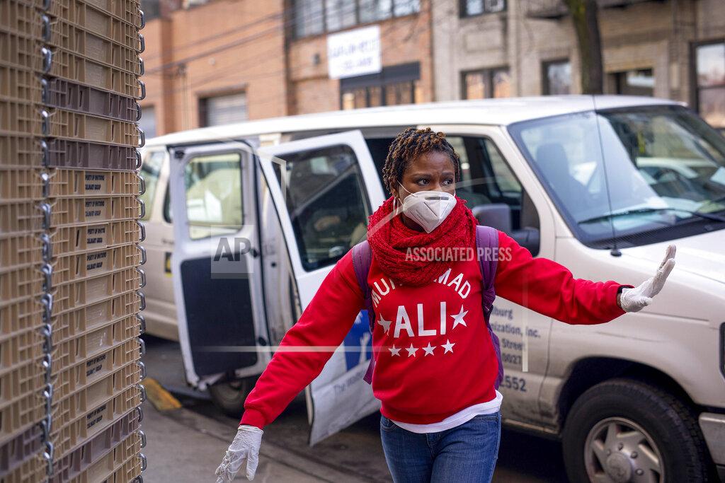Robert Bumsted FILE - In this April 6, 2020, file photo, Carla Brown, executive director for the Charles A. Walburg Multi-Service Organization, arrives to pick up meals from a caterer in the Queens borough of New York. The coronavirus pandemic has kept loved ones apart, with younger family members fearful of bringing the disease to older relatives who may be so much more susceptible. That's driven Brown even more to assure those elderly are receiving the care they need through her meals-on-wheels program. (AP Photo/Robert Bumsted, File)
