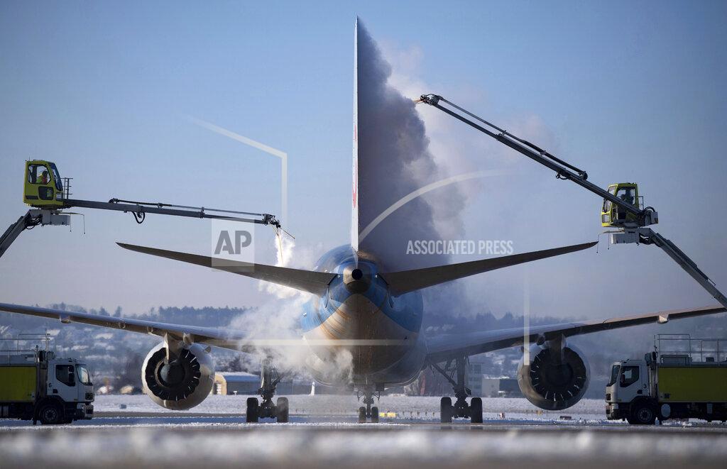 Marijan Murat An aircraft is de-iced at Stuttgart Airport before take-off in Stuttgart, Germany, Friday, Feb. 12, 2021 . (Marijan Murat/dpa via AP)