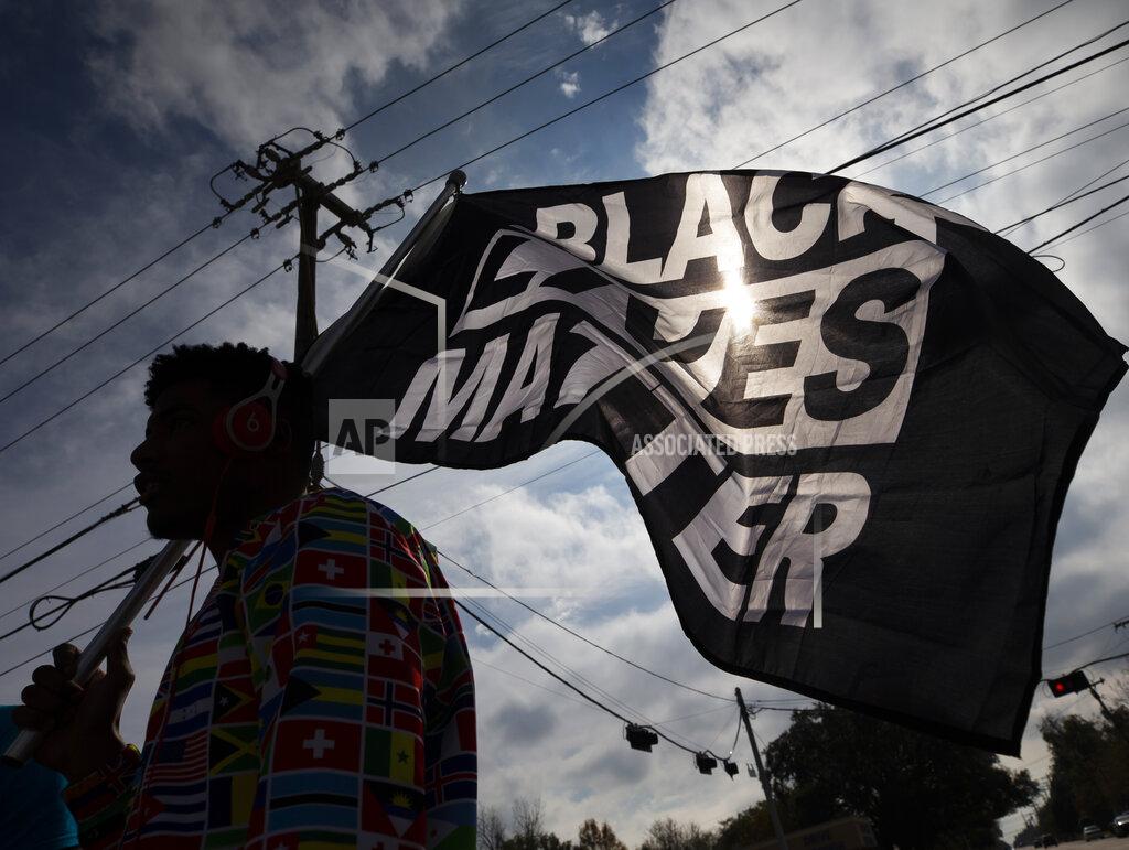 Stuart Villanueva FILE - In this Dec. 12, 2020, file photo, MD Crawford carries a Black Lives Matter flag before a march in La Marque, Texas to protest the shooting of Joshua Feast, 22, by a La Marque police officer. A financial snapshot shared exclusively with The Associated Press shows the Black Lives Matter Global Network Foundation took in just over $90 million last year. (Stuart Villanueva /The Galveston County Daily News via AP, File)