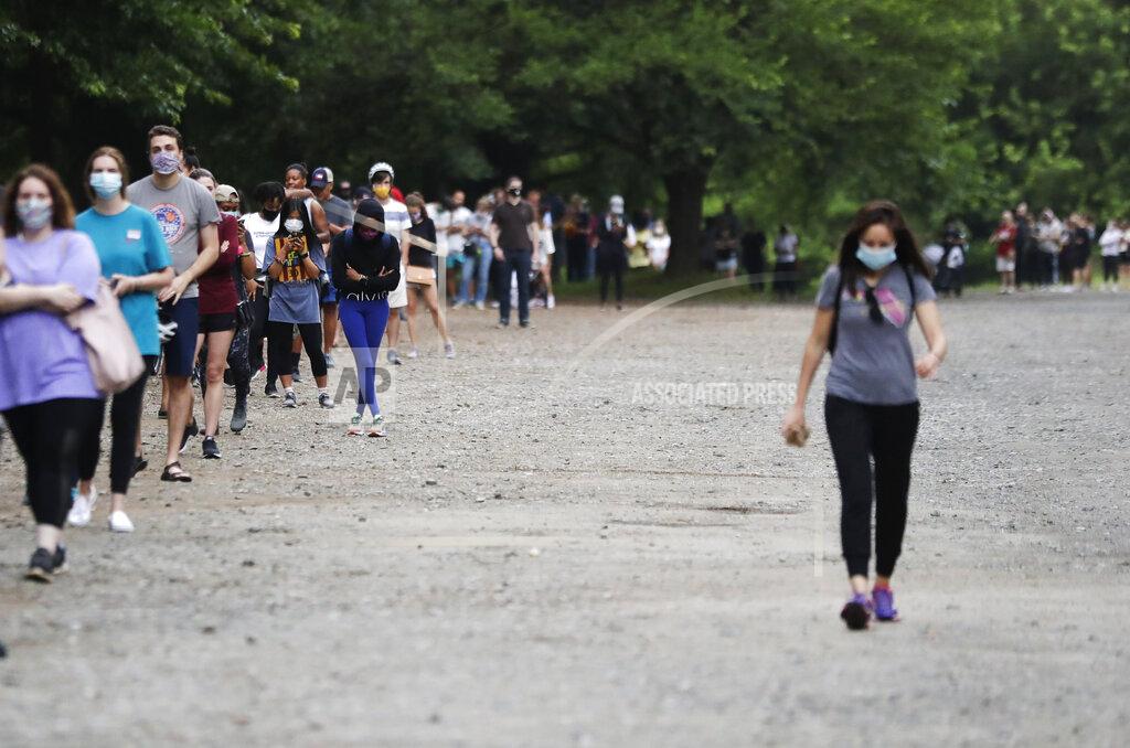 Brynn Anderson People wait in line to vote in the Georgia's primary election at Park Tavern on Tuesday, June 9, 2020, in Atlanta. (AP Photo/Brynn Anderson)