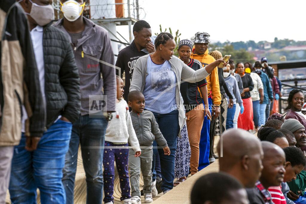 Jerome Delay Residents from the Alexandra township in Johannesburg gather in a stadium to be tested for COVID-19 Monday, April 26, 2020. South Africa will began a phased easing of its strict lockdown measures on May 1, although its confirmed cases of coronavirus continue to increase. (AP Photo/Jerome Delay)