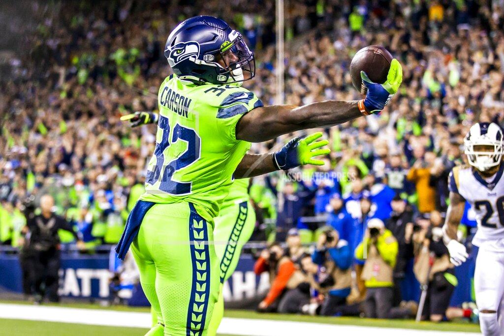 Andy Bao Seattle Seahawks running back Chris Carson bobbles but brings down a 5-yard touchdown reception during the fourth quarter against the Los Angeles Rams in an NFL football game in Seattle on Thursday, Oct. 3, 2019. The Seahawks won 30-29. (Andy Bao/The Seattle Times via AP)