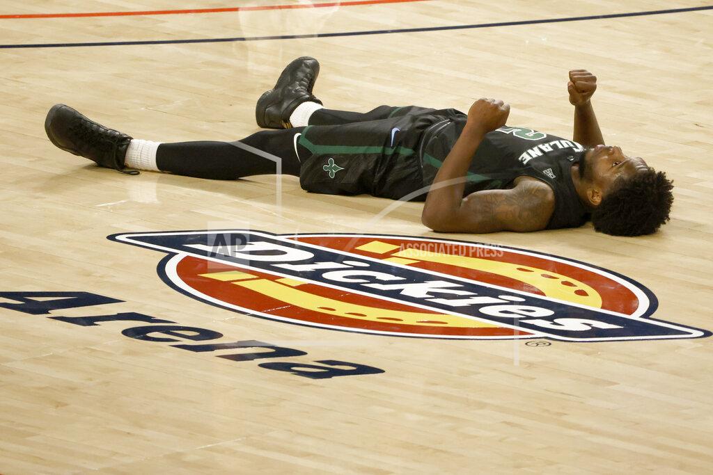 Ron Jenkins Tulane guard Jordan Walker (2) stays on the floor for a moment after a collision against Houston during the second half of an NCAA college basketball game in the quarterfinal round of the American Athletic Conference men's tournament Friday, March 12, 2021, in Fort Worth, Texas. (AP Photo/Ron Jenkins)